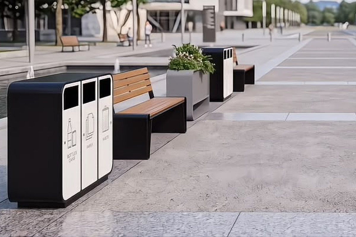 Waste-sorting outdoor recycling bins and a hardwood park bench arranged along a paved public plaza