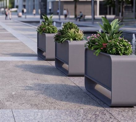 Metal planters along a plaza walkway